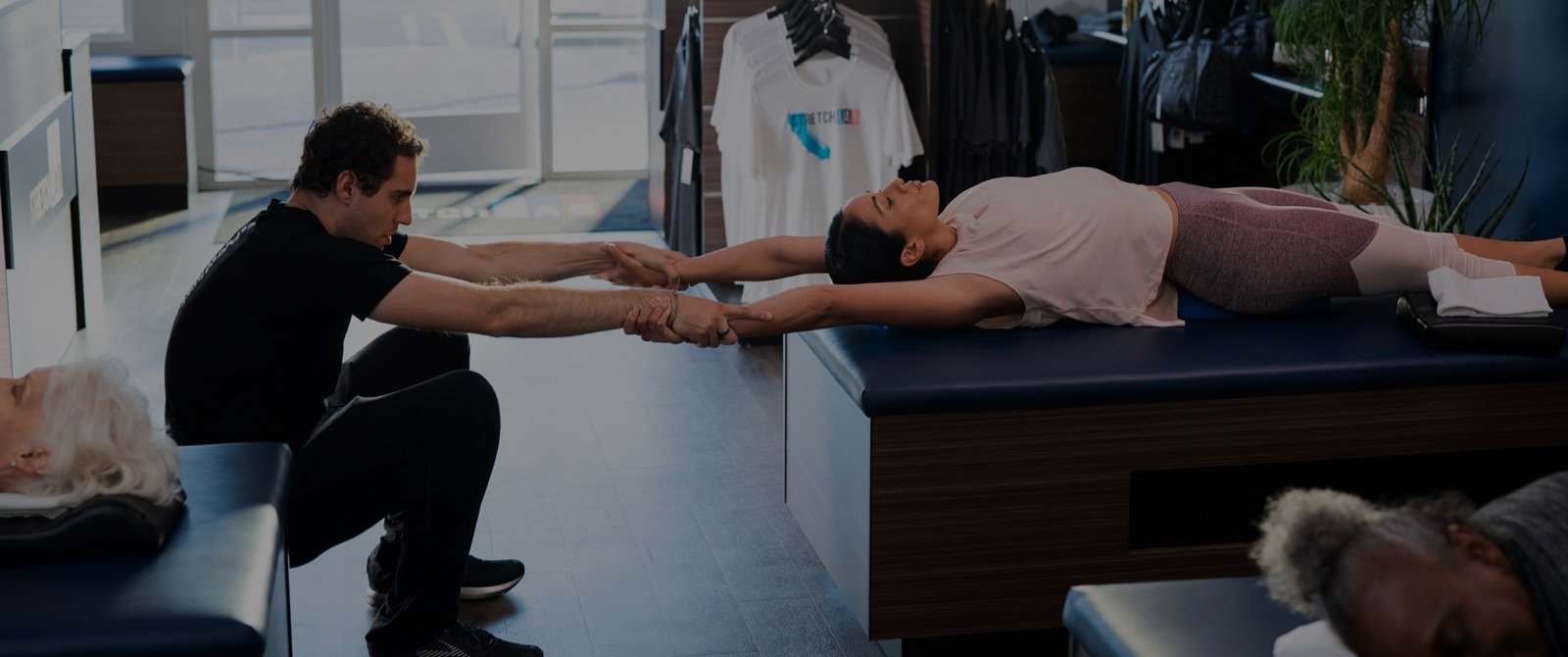 StretchLab instructor assisting person with stretch